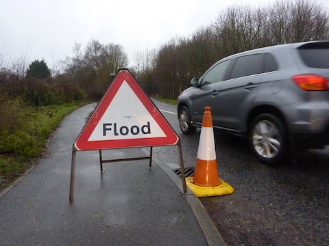 Warning of a flood water on the road at Clay Lane, near Jacobs Well.