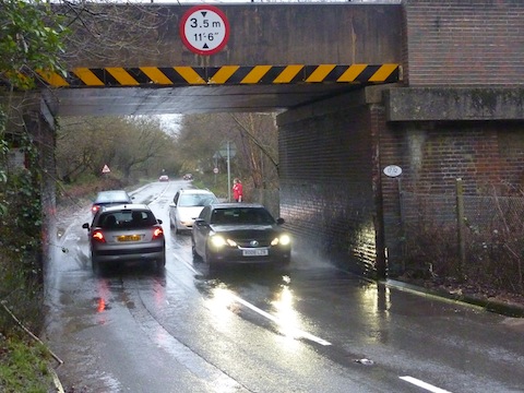 Drivers should take care as there is a good deal of surface water on roads as seen here under the railway bridge on Salt Box Road.
