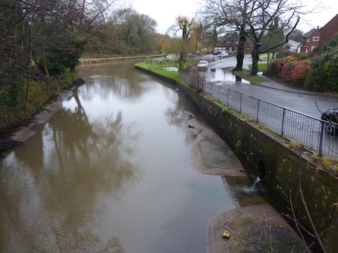 As part of the flood managment on the River Wey Navigations the water level at the cut here at Stoke Bridges is remarkably low. Note the water on the road - a spot that regularly floods.