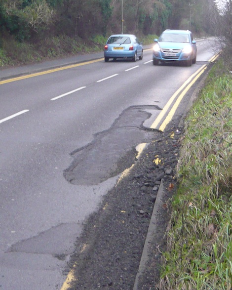 Another damaged road surface on the Horsham Road by Shalford Park