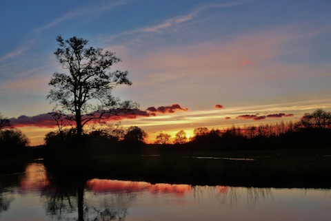 A scenic sunset looking across the River Wey towards the recycling depot at Slyfield.