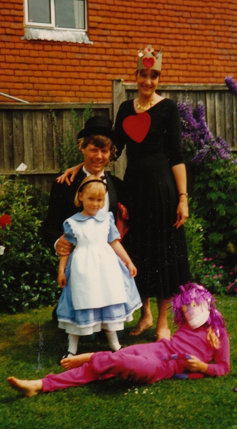 Emma in pink with her Mum, Dad and little sister Ellen in the garden of their Shalford home ready for an Alice in Wonderland Party