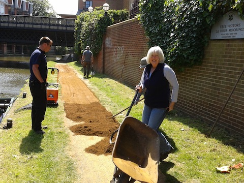 Volunteers help to re-lay the towpath near Onslow Bridge in Guildford.