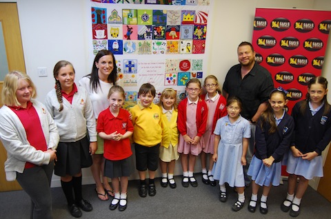 Some of the children who helped to make the quilt with Eagle Radio's Peter Gordon and Breakfast Bev.
