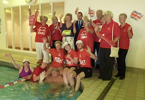 The Mayor of Guildford, Diana Lockyear-Nibbs presents the defibrillator machine to the health club. Pictured with her are Spirit staff and local BHF fundraisers.