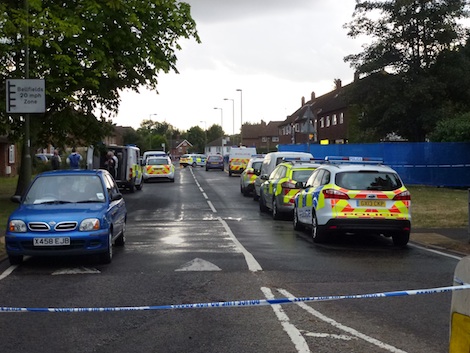 Police cars crowd in near the scene of the incident while the Woking Road entrance to Bellfields remained closed.