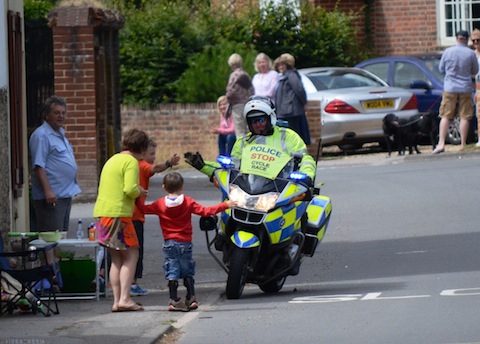 A motorcycle cop has a chat to a young onlooker.