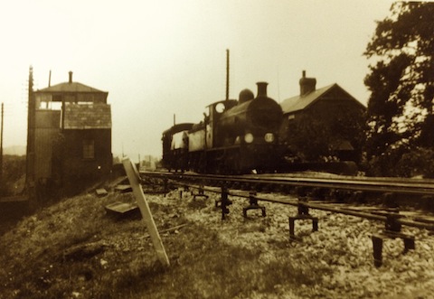 Shalford Junction: the box is on the left. The photo looks to have been taken not long after the London Waterloo to Portsmouth was electrified in 1937. The train may well be a pick-up goods. Can anyone name the class of locomotive?