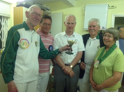 President Derek Redgewll presents the winners' trophy to the team of (from left) Paul Plummer, Patrick Andrew, John Heyes, and Mary Redgwell.