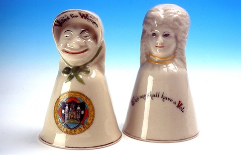 Two sides of a China figure representing women's suffrage with the Guildford town crest upon it.