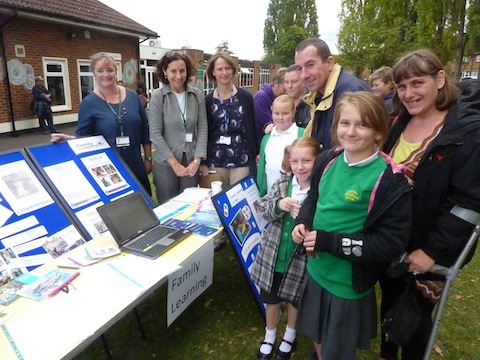 Some parents and children take a look at Family Learning group’s table of information.