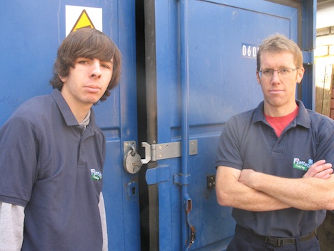 Trainee Doug Craig (left) with Plantation Trading co-ordinator Mark Coupland beside the damaged storage unit.