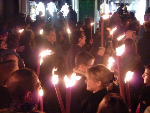 The torches are lit in the High Street before the procession to Stoke Park.