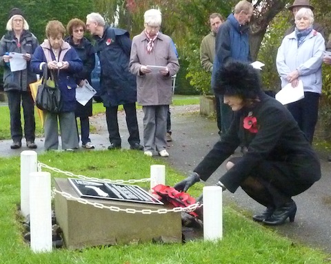 The clerk of Worplesdon Parish Council, Gaynor White, lays a wreath at the war memorial in Jacobs Well.