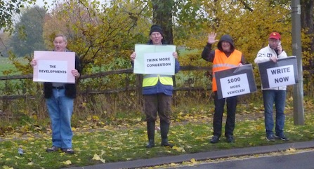 Protesters make their feelings known to passing motorists.