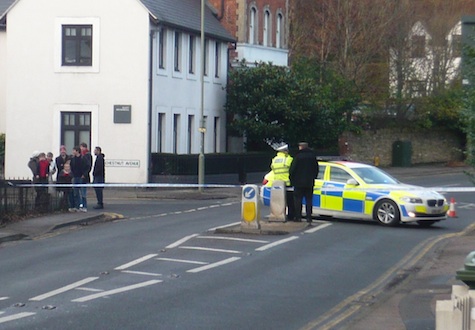 Curious residents stand by the cordon in place across the Portsmouth Road 100 metres north of the hostel which is the centre of the police incident.