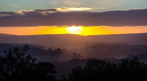 The sun climbs higher over a beautiful Surrey landscape.