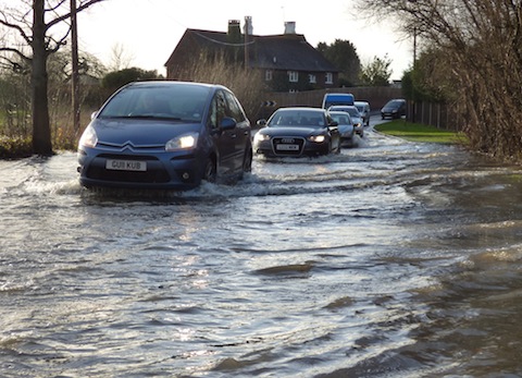 Vehicles drive through the floods in Clay Lane, Jacobs Well.