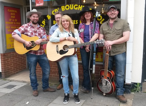 Kelly Lee Band pictured outside Ben's shop in Tunsgate.