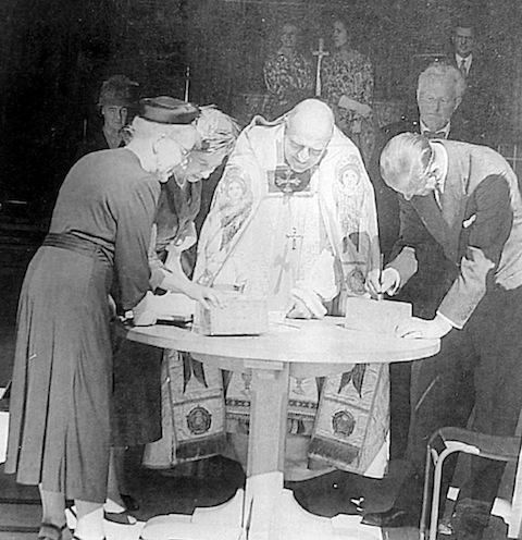 The Queen and the Duke of Edinburgh sign a brick while visiting the unfinished cathedral in 1957.