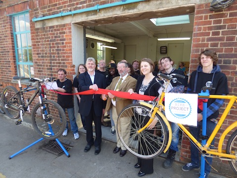 John Thurlow, Mayor David Elms, and laura Thurlow cut the ribbon pictured with some of the young people who work at The Guildford Bike Project.