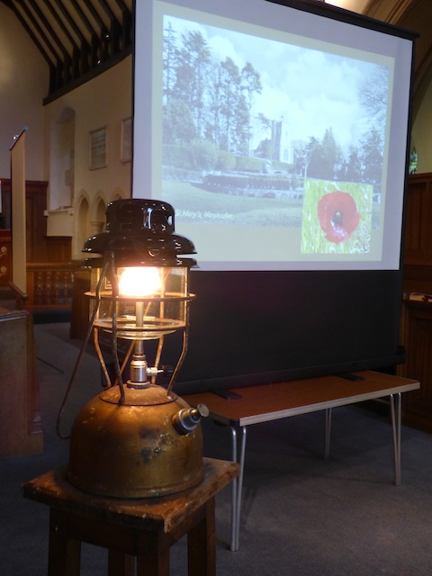 The tilley lamp burns during the service.