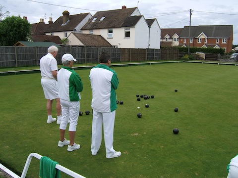 Castle Green players Diana Summeryahes and Paul Plumber with a Milford player watching the head build as the skips take their turn. 