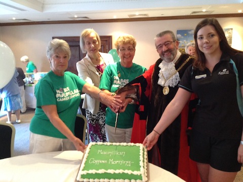 Cutting a special cake at the Macmillan World's Biggest Coffee Morning at Guildford's Holiday Inn.