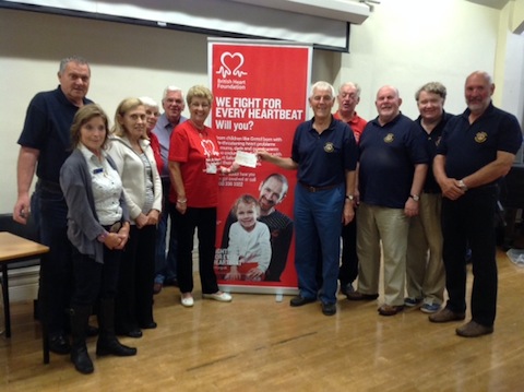 A cheque for £1,059 is presented by Godalming Lions to the Guildford and Godalming branch of the British Heart Foundation.