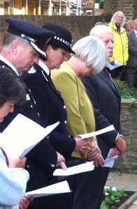 Surrey's Cheif Constable bows her head in reflection amongst those gathered in Quakers' Acre to commemorate the fortieth anniversary of the Guildford pub bombings.