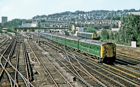4COR 3123 and 4BUF 3081 leave Guildford on a Portsmouth to London Waterloo fast service with sister unit 4COR 3114 stabled in the up sidings on 18th July 1970. Photo: Gordon Edgar.