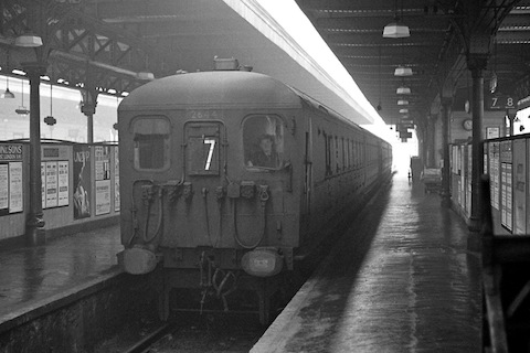 A murky morning as the 10.53 stopping service leaves Guildford from platforms 6 and 7 (up the Gulley) circa 1965. The train consists of 2x2HAL units, the leading unit being No. 2644. The headcode stencil 7 denotes the train is a stopping service to London Waterloo via Woking. Photo: Leigh Darnton.