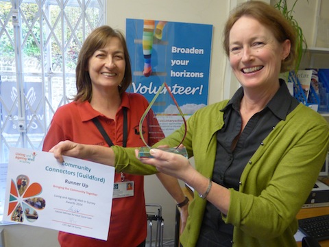 Denise Graves (right) is presented with the award for Community Connectors by Guildford Borough Council community warden Tracy James.
