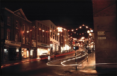 This picture, looking up Guildford High Street, gives a clue to the date when the picture was taken. Woolworths can be seen, which opened in about
