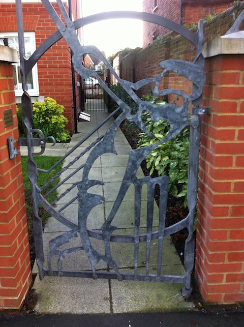 A gate featuring a cricketer. Where can it be found?