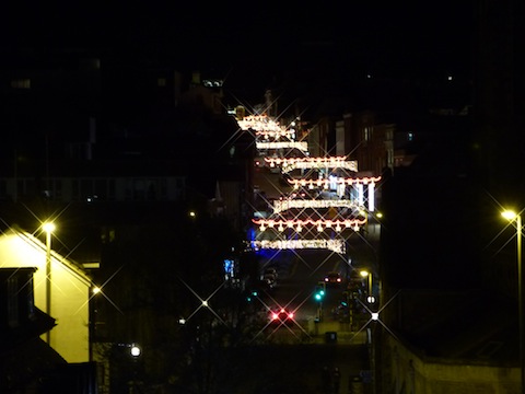 Standing roughly at the same spot in The Mount as the earlier photo, this view taken with a telephoto lens captures the current Christmas lights in the High Street.