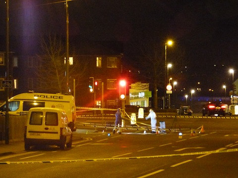 Aldershot Road at its junction with Worplesdon Road and Woodbridge Hill on Monday evening with police officers carrying out investigations.
