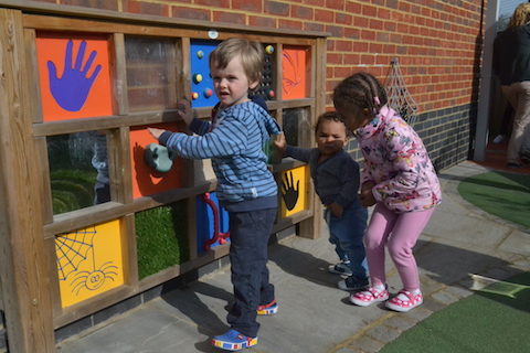 At the Spinney Children's Centre There is a wall full of curiosities with something to touch, something to grab and something to open.