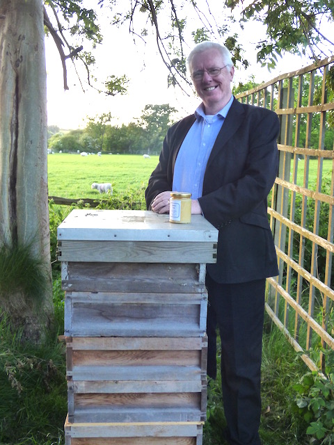 Beekeeper Hugh Coakley with one of his hives.