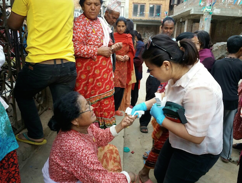 Shuva Ghale Gurung administering first aid to a victim of the earthquake in Kathmandu.