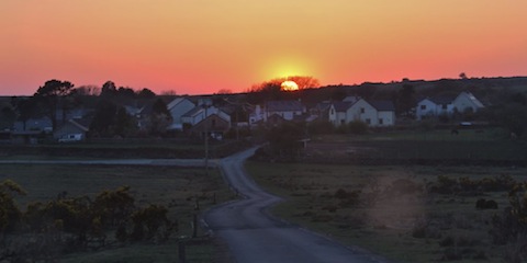 Sun sets over a Cornish village.