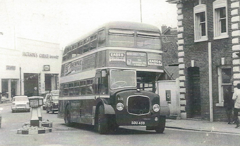 Can you name the street where this bus is and add details about the vehicle?