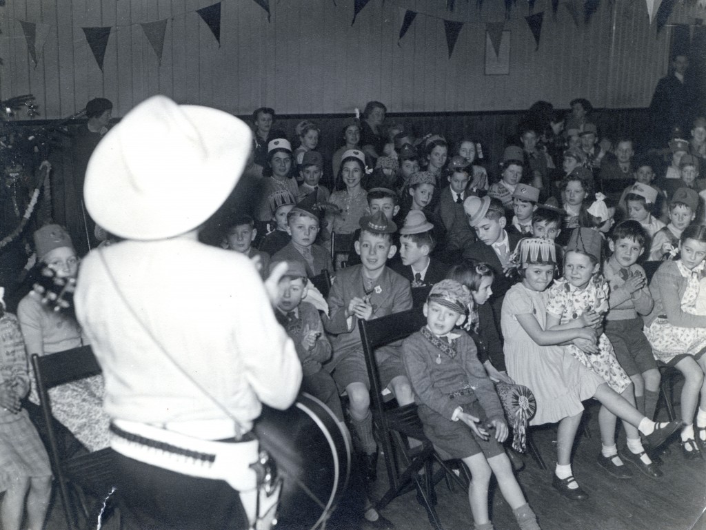Children enjoy a Christmas party. John says the cowboy was an imported professional entertainer.
