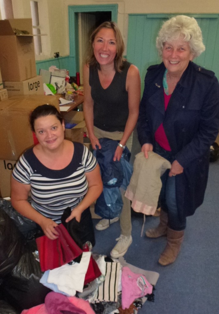 Paula Fuentes, left and Cllr Caroline Reeves right help to sort out the donations brought to the hall.