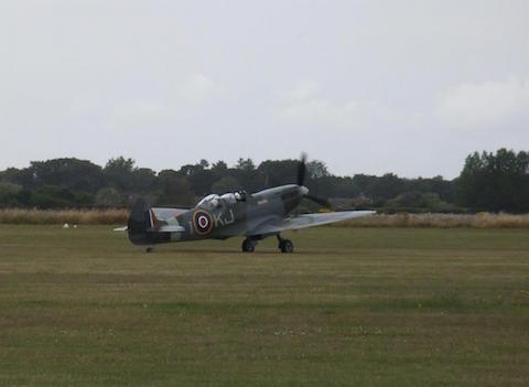 Vickers Supermarine Spitfire TR9, SM520 at Goodwood 5.8.15. Taxiing across the grass airfield.