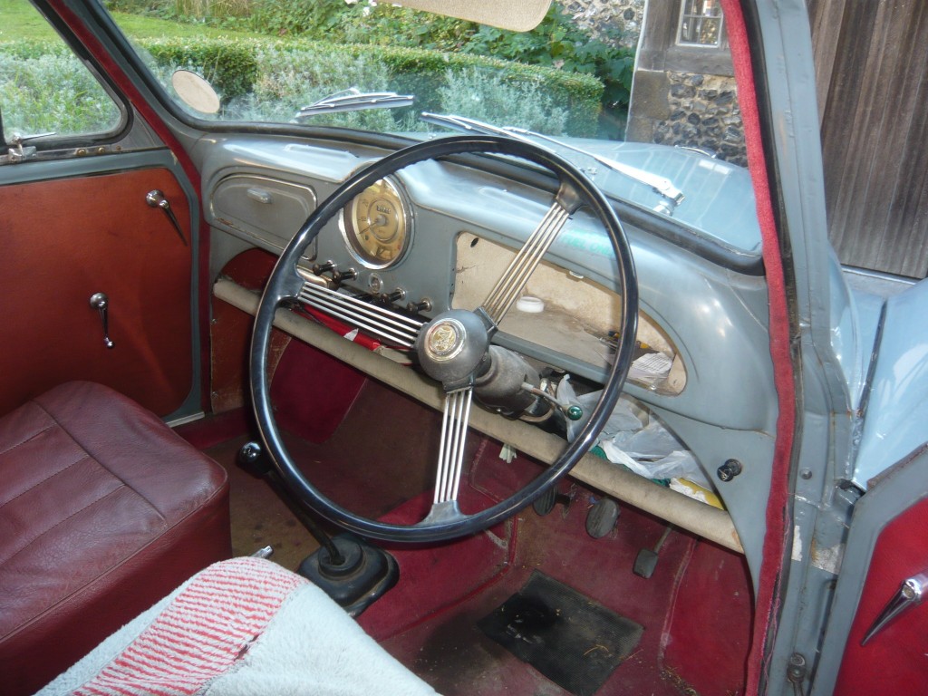 The utilitarian interior of a 1950s motor car.