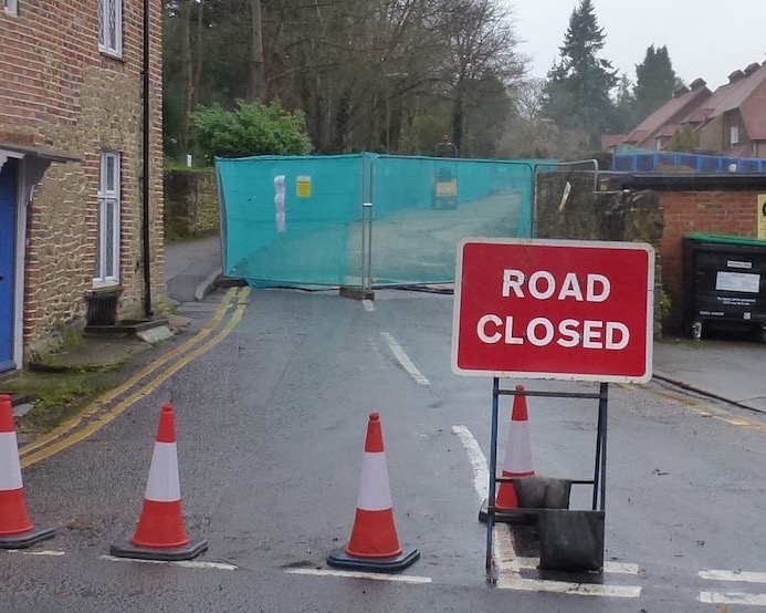 The entrance to Sandy Lane off the A3100 Portsmouth Road.