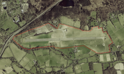 Aerial photograph of the site marked in red of the proposed development. From Guildford Borough Council's planning officers' report.