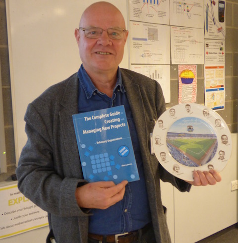 Nigel Smallbone led a workshop based on his personal thoughts on developing and generating new projects. he is pictued with a book her urged attendees to read and brought along a commemorative plate linked to football and a man of vision Jimmy Hill.