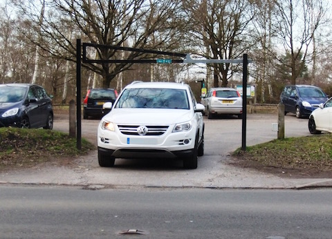 Vehicle leaving single width car park access.